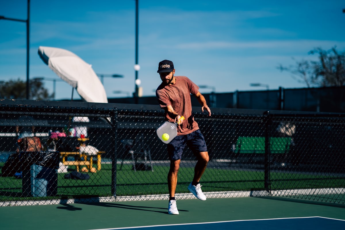 A player set up to swing through a powerful shot on the pickleball court