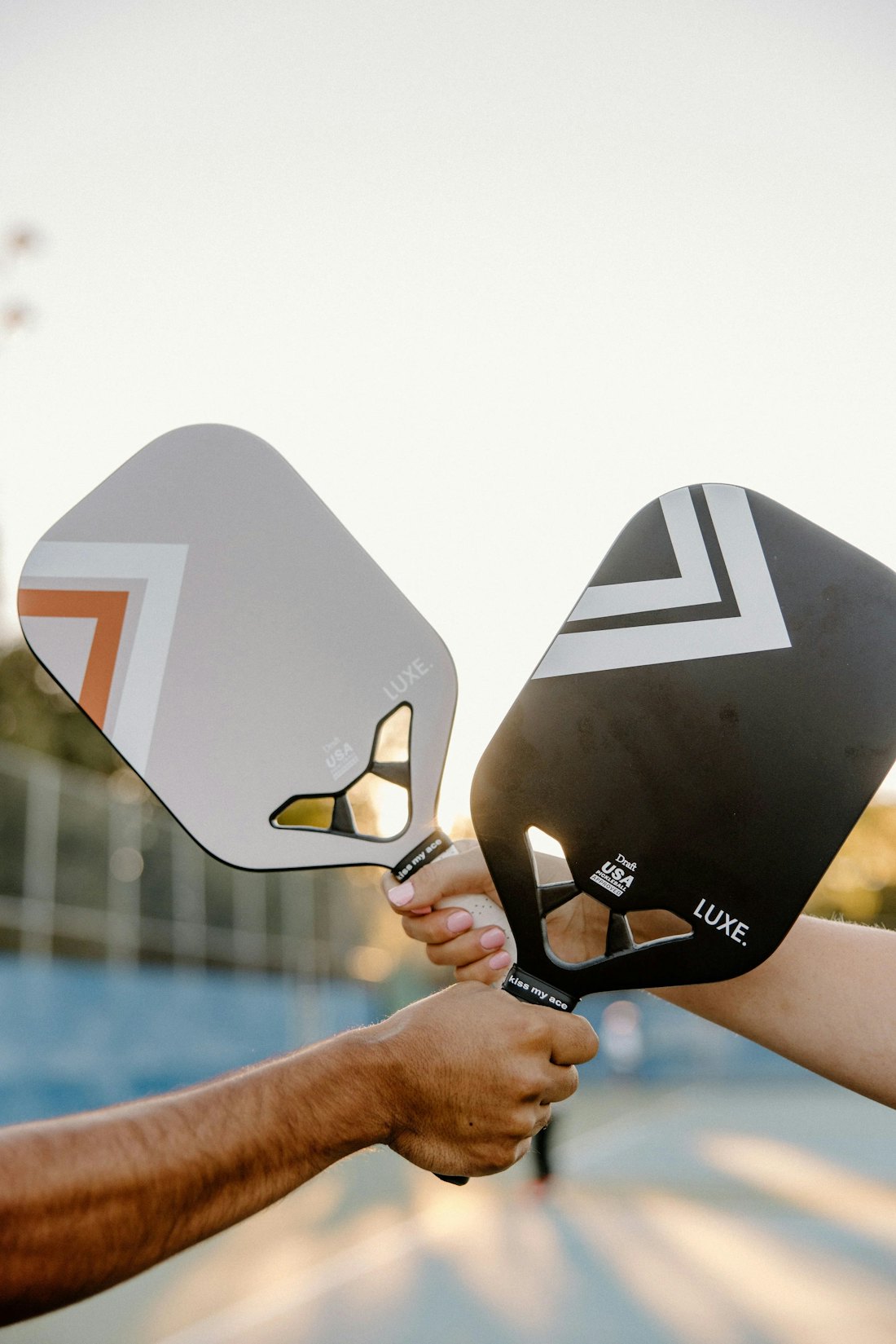 Two players holding pickleball paddles ready for a doubles match on a Utah outdoor court